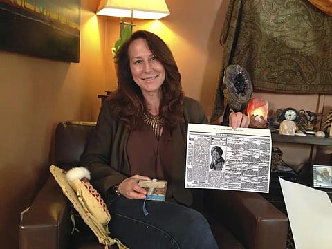 Betsy Roddy holds a copy of the Aug. 17, 1910, edition of The River Press of Fort Benton, Mont., on June 12, 2017. The newspaper was one of the first to report on Father's Day..(File Photo | AP)