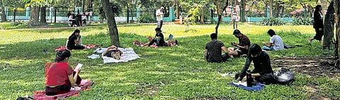 Members of ‘Cubbon Reads’ are all smiles as they pose with their stack of books and artwork.