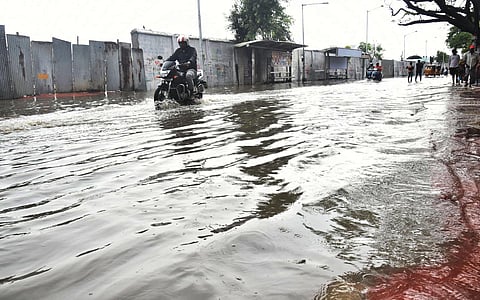 Motorcyclists drive past the waterlogged road at Ambedkar college road, Pulianthope in Chennai. (Photo | P Jawahar, EPS)