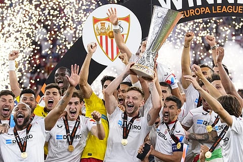 Sevilla's team captains Ivan Rakitic, center, and Jesus Navas, center right, lift the trophy after winning the Europa League final soccer match between Sevilla and Roma. (Photo | AP)
