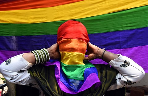 A participant covering face with a pride flag at a rally for celebrating the beginning of Pride Month in Chennai. (Photo | P Ravikumar, EPS)