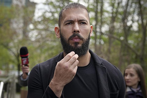Andrew Tate touches his beard after leaving the Bucharest Tribunal, in Bucharest, Romania. (Photo | AP)