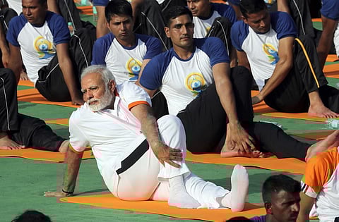 FILE - Indian Prime Minister Narendra Modi performs yoga to mark International Day of Yoga in Dehradun, India, Thursday, June 21, 2018. (Photo | AP)