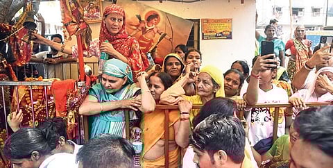 Locals gather outside the temple in Mandawali on Thursday. (Photo | Parveen Negi)