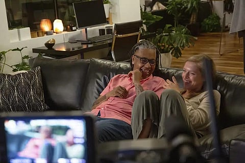 This image released by Focus Features shows Sean Saifa Wall, left, and Alicia Roth Weigel during the filming of the documentary 'Every Body.' (Focus Features via AP)