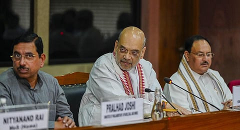 Union Home Minister Amit Shah with Union Minister Pralhad Joshi and BJP National President J.P. Nadda during an all-party meeting on violence in Manipur.(Photo | PTI)