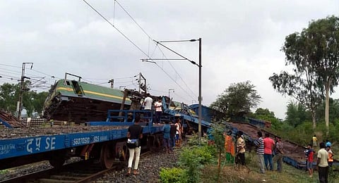 Locals gather at the site after two goods trains collided with each other that resulted in the derailment of several boggies near West Bengal's Bankura. (Photo | PTI)