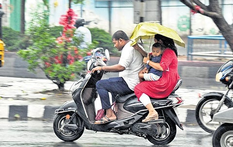 A woman uses umbrella as rain lashed Vizag on Saturday I G Satyanarayana