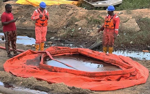 In this grab taken from video, workers stand by a container to collect oil spill waste, in Ogoniland, Nigeria, June 16, 2023. (Photo | AP)