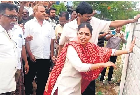 Tuljabhavani Reddy, daughter of MLA M Yadagiri Reddy, tries to demolish the compound wall of the site in Cherial on Sunday.