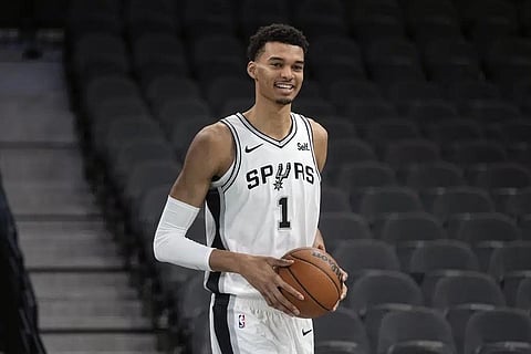 San Antonio Spurs' Victor Wembanyama, the No. 1 draft pick, handles a ball during an NBA basketball press conference, June 24, 2023, at the AT&T Center in San Antonio. (Photo | AP)