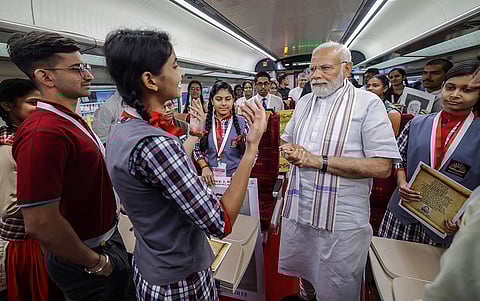 PM Narendra Modi interacts with students aboard a Vande Bharat Express during the flagging off ceremony of five Vande Bharat Express trains from Rani Kamlapati Railway Station, in Bhopal. | PTI