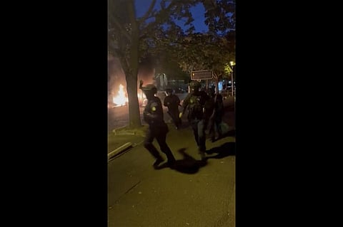 police officers try to control people on a street in Nanterre. (Photo | AP)