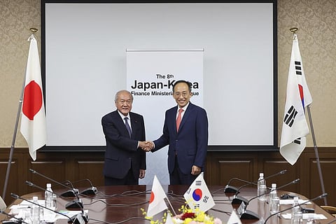 Japanese Finance Minister Shunichi Suzuki, left, and South Korea's Economy and Finance Minister Choo Kyungho . (Photo | AP)