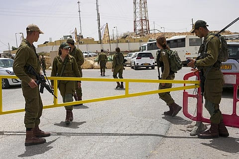 Israeli soldiers secure a gate leading to a military base following a deadly shootout in southern Israel along the Egyptian border. (Photo | AP)