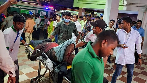 A man injured in the train mishap being carried on a stretcher to a hospital | Express