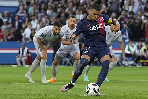 PSG's Kylian Mbappe scores his side's second goal from a penalty kick during the French League One soccer match between Paris Saint-Germain and Clermont. (Photo | AP)