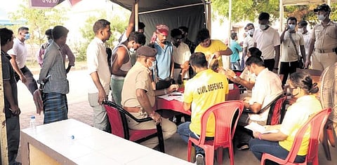 People inquire about their relatives at the help desk on AIIMS premises