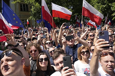 People participating in the anti-government march in Poland criticizing the current government's policies including Presidential pardon for top officials. (Photo | AP)