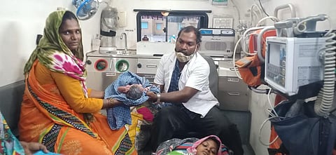 A mother poses with her newborn after delivering the baby inside an ambulance in Koppal district. (Photo | Express)