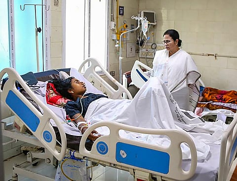 West Bengal Chief Minister Mamata Banerjee meets a passenger injured in the triple-train accident, at a hospital in Cuttack (Photo | PTI)