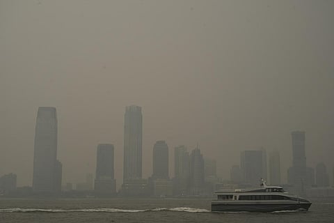 Buildings in Jersey City, N.J. are partially obscured by smoke from Canadian wildfires. (Photo | AP)