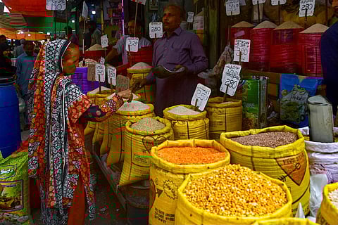 A customer buys rice at a wholesale shop in Karachi on June 8, 2023. (Photo | AFP)