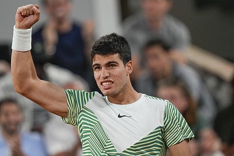 Carlos Alcaraz clenches his fist after scoring a point against Stefanos Tsitsipas during their quarterfinal match of the French Open at Roland Garros in Paris, Tuesday, June 6, 2023. (Photo | AP)