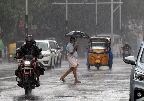 Commuters on a road amid rainfall, in Thiruvananthapuram, Wednesday, June 7, 2023. (Photo | PTI)