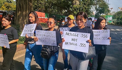 Kuki community people from Manipur display placards during a protest outside Union Home Minister Amit Shah's residence against the ongoing violence in the northeastern state. (Photo | PTI)