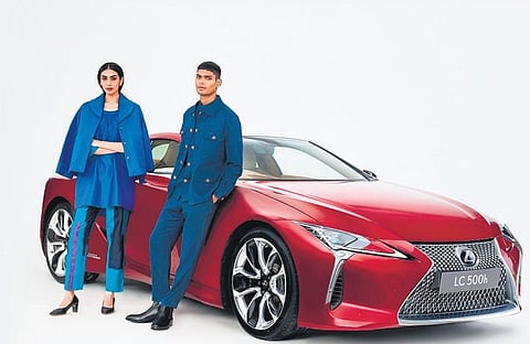 Models in limited-edition jackets  in front of the new Lexus LC 500h