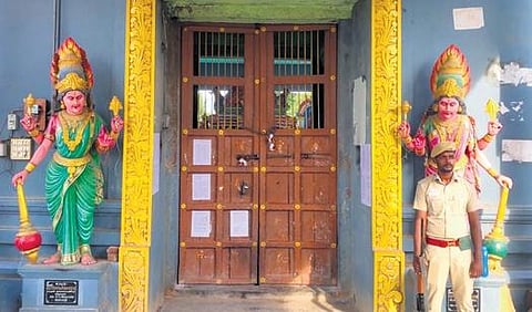A policeman guarding the sealed Sri Dharmaraja Draupadi Amman Temple at Melpathi village (Photo | Express)