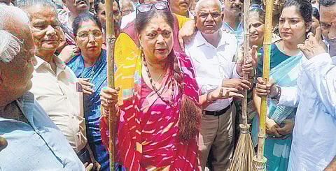 Vasundhara Raje Scindia takes part in a cleanliness drive outside Sheetala Mata temple in Udaipur on Saturday | pti
