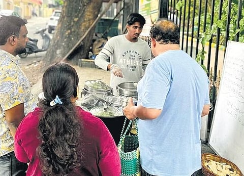 ​  People at the make-shift food stall  ​
