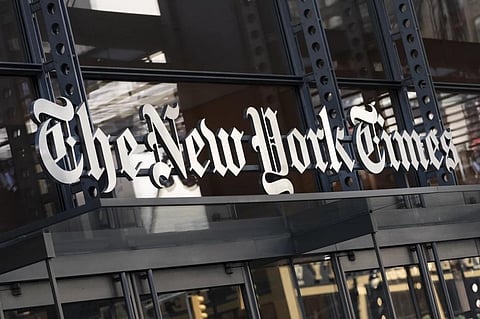 A sign for The New York Times hangs above the entrance to its building, May 6, 2021. (File Photo | AP)