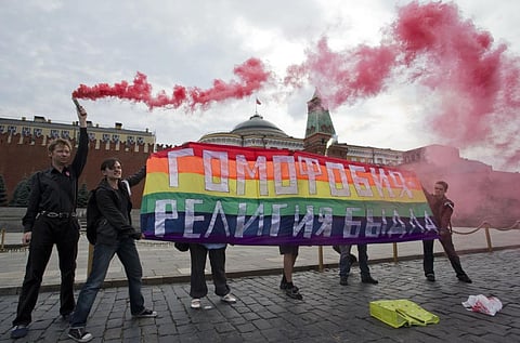 Representational image of gay rights activists holding a banner that reads, 'Homophobia- the religion of bullies.' (Photo | AP)