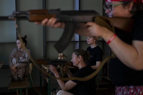 Participants takes aim with mock AK-47 rifles during firarms training for civilians amid the country's ongoing war against Russia in Kyiv, Ukraine. (Photo | AP)