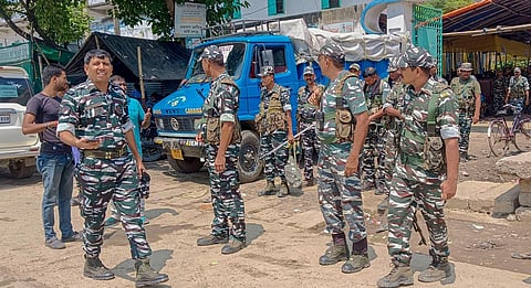 Security personnel stand guard outside a strong room where ballot boxes are kept a day after the West Bengal's panchayat polls, at Gazole in Malda district, Sunday, July 9, 2023. (PTI)