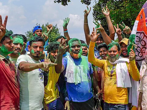 TMC workers and supporters celebrate the party's lead during the counting of votes of the West Bengal panchayat polls, in Bankura district (Photo | PTI)