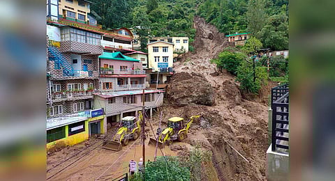 Earthmovers on restoration work as massive landslide damaged buildings at Shamti after heavy monsoon rainfall, in Solan district, Himachal Pradesh, Tuesday, July 11, 2023. (Photo | PTI)