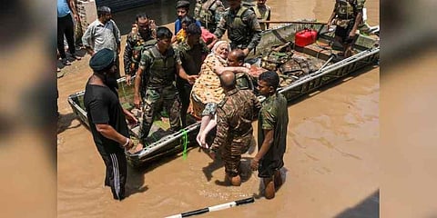Indian Army personnel rescue people stuck in a flooded residential area after an increase in the water level of Badi Nadi river following heavy monsoon rain, in Patiala on July 11. (Photo | PTI)