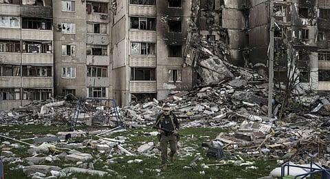 FILE - A Ukrainian serviceman walks amid the rubble of a building heavily damaged by multiple Russian bombardments near a frontline in Kharkiv, Ukraine, Monday, April 25, 2022 (Photo | AP)
