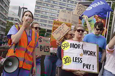 Members of the Unite union stand on the picket line outside Guys and St Thomas' Hospital during a 24 hour strike. (Photo | AP)