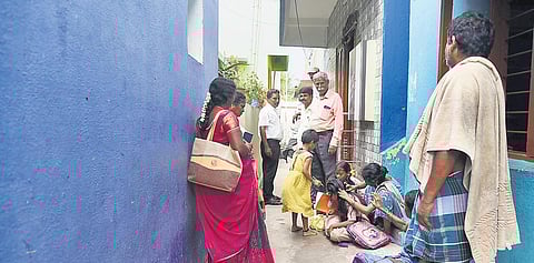 Residents of Thalankuppam sitting on a lane leading up to the toilet | P Ravikumar