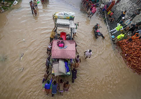 : People from low-lying areas around the Yamuna river move a tractor stuck in floodwaters, in New Delhi (Photo | PTI)
