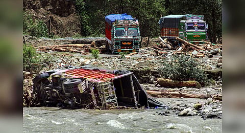 A truck after it got swept away in floodwater following heavy monsoon rains, in Kullu, Wednesday, July 12, 2023. (Photo | PTI)