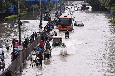Vehicles make their way through a waterlogged road at ITO as the Yamuna river floods nearby areas, in New Delhi, Friday, July 14, 2023. (Parveen Negi, EPS)