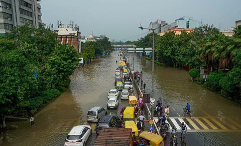 Vehicles make their way through a waterlogged road at ITO as the Yamuna river floods nearby areas, in New Delhi, Friday, July 14, 2023. (PTI)