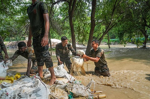Army personnel carry out repair work after the drain regulator at ITO was damaged due to flooding in the area by the Yamuna river, in New Delhi, Friday, July 14, 2023. (Photo | PTI)