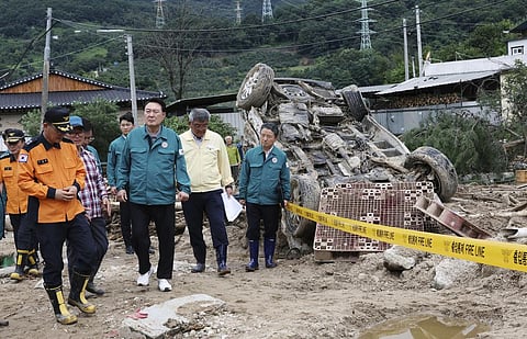 South Korean President Yoon Suk Yeol, fourth from left, looks around a flood damaged area in Yecheon, South Korea, Monday, July 17, 2023. (Photo | AP)